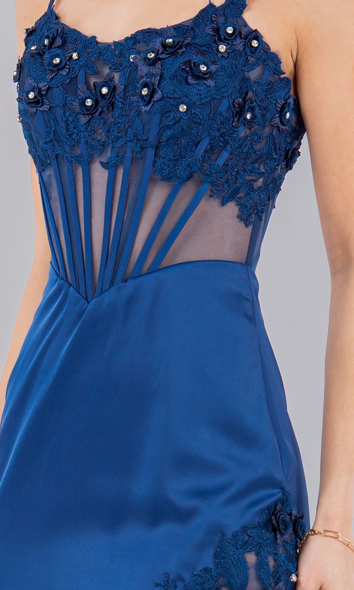 Woman wearing the Cinderella Couture 8085J Long Corset Prom Dress in royal blue, designed with floral lace, beaded embroidery, and sheer mesh panels on the bodice.